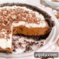 Square image of Chocolate Cream Pie with slices removed showing the filling.