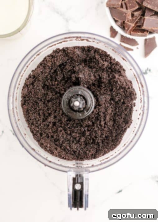 Oreos and butter mixed together in food processor.