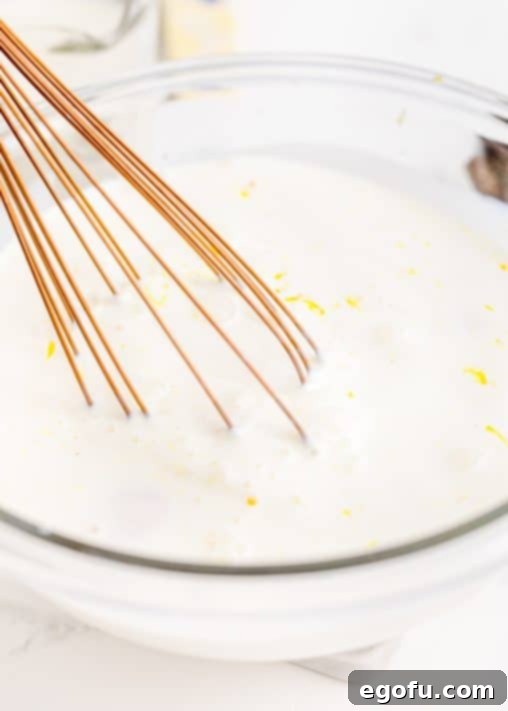 Half and half and egg yolks mixed together in bowl.