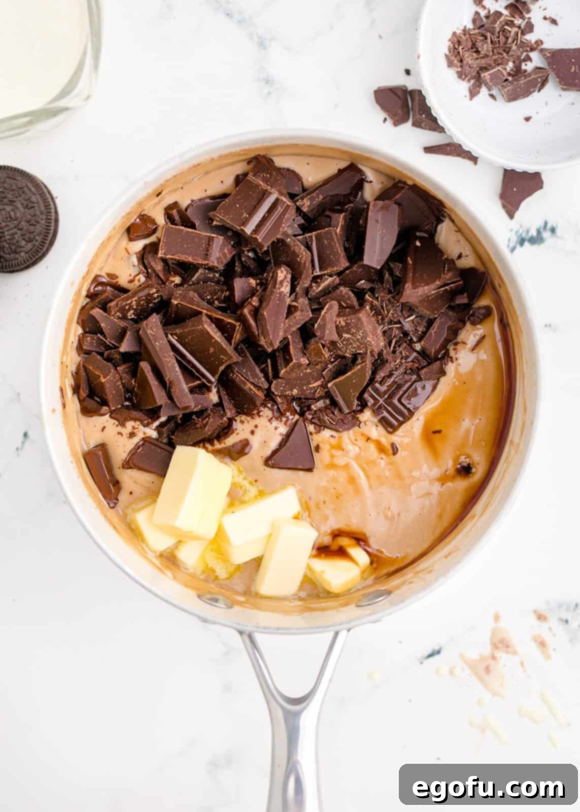 Butter, chopped chocolate, and vanilla extract added to the hot egg and half and half mixture in the pan.