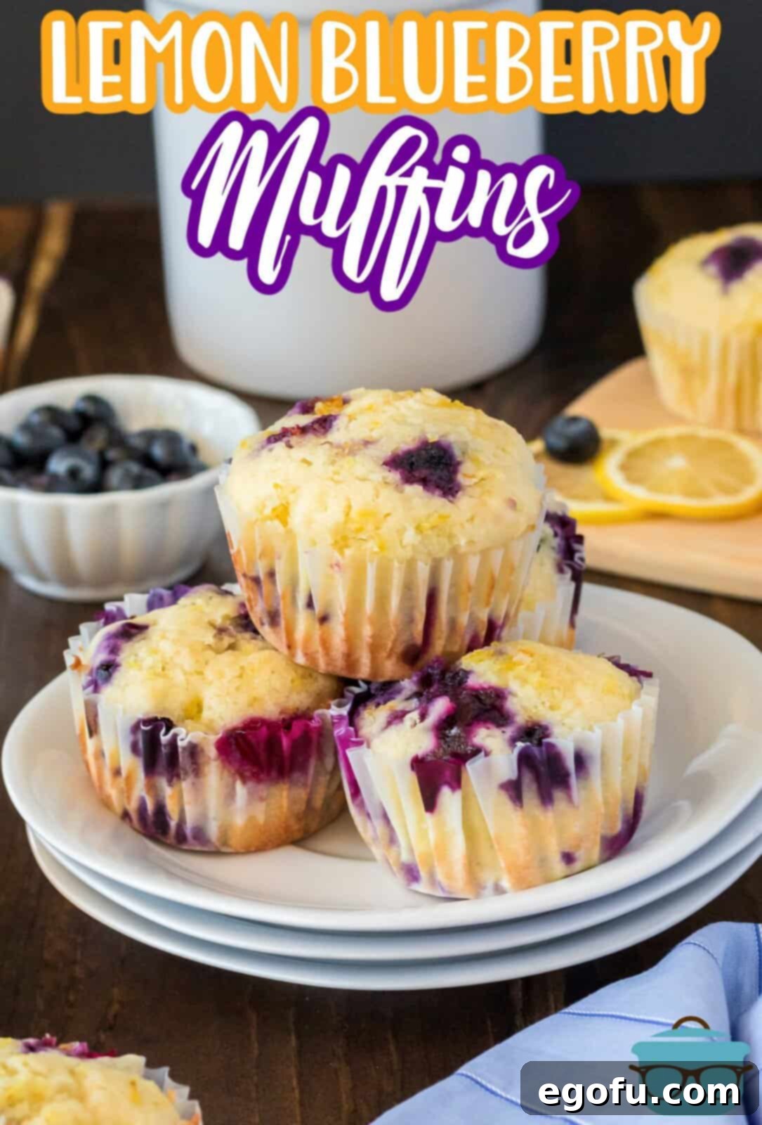 Stacked Lemon Blueberry Muffins on white plate.