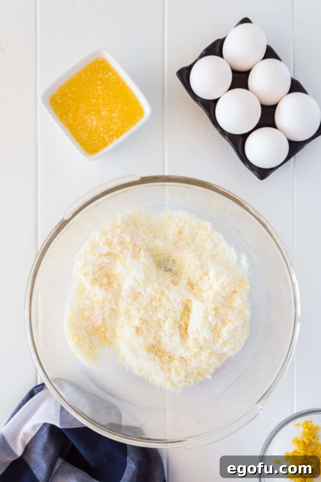 Lemon zest and sugar rubbed together in bowl.