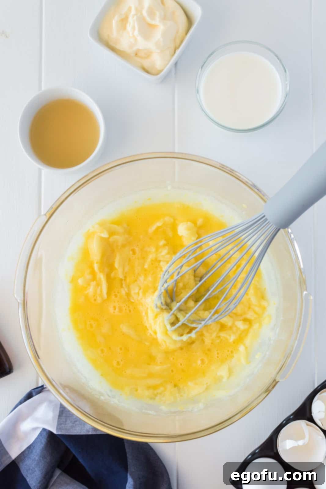 Butter, ggs, lemon juice, milk, yogurt, and almond extract whisked into the sugar mixture.