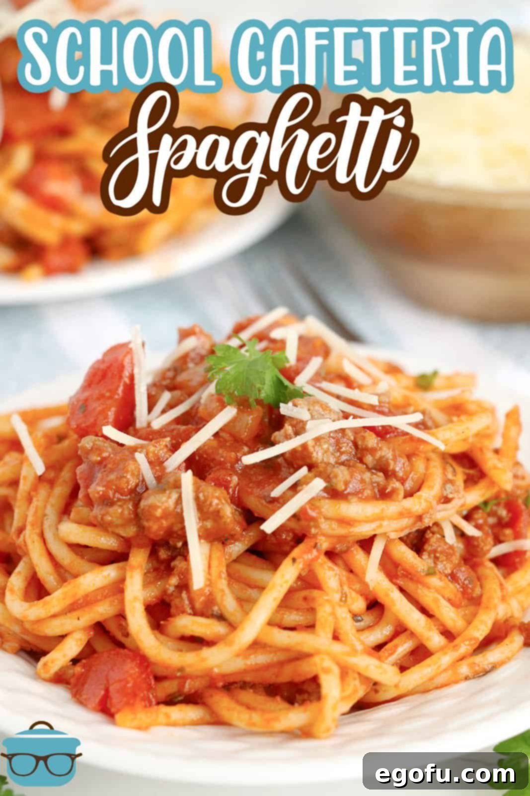 Our School's Spaghetti Day 3 Pinterest image of a plate full of School Cafeteria Spaghetti with cheese and basil leaf.