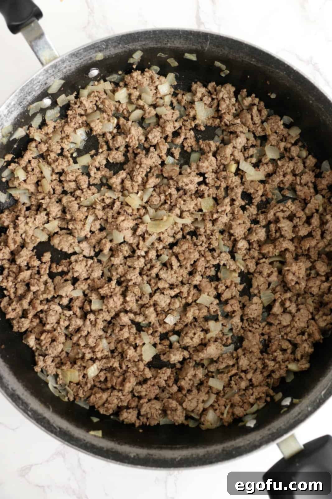 Our School's Spaghetti Day 5 Cooked ground beef and onion in pan.