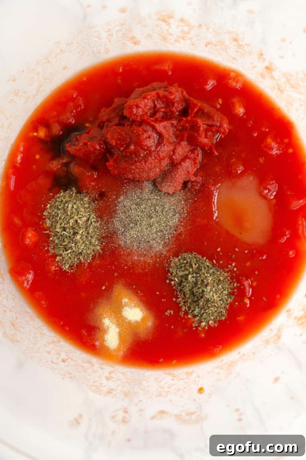 Our School's Spaghetti Day 6 Tomatoes, tomato juice, tomato paste, sugar, worcestershire sauce, oregano, basil, garlic powder, salt, and pepper added to bowl.