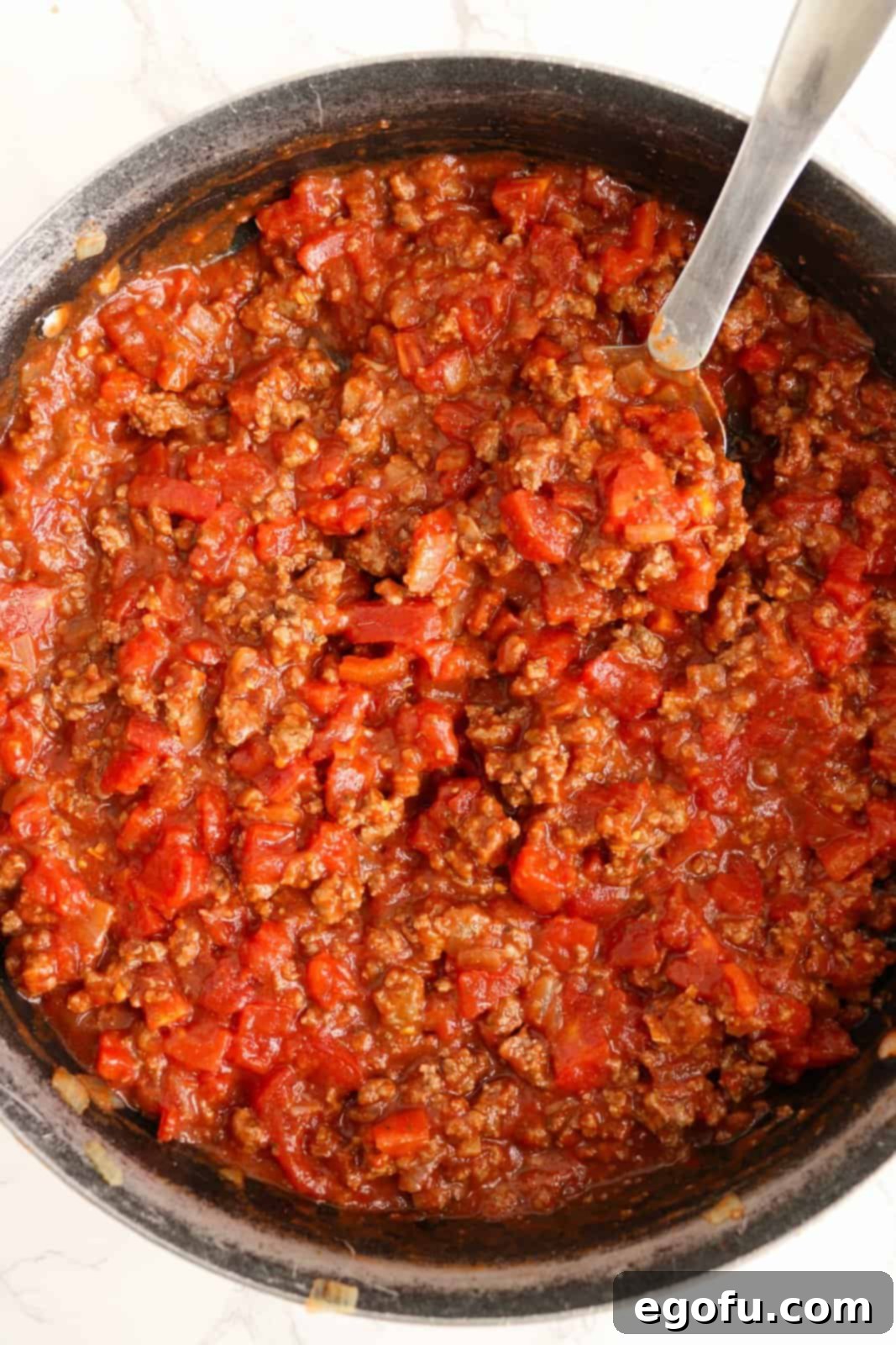 Our School's Spaghetti Day 9 Tomato mixture added to beef mixture.