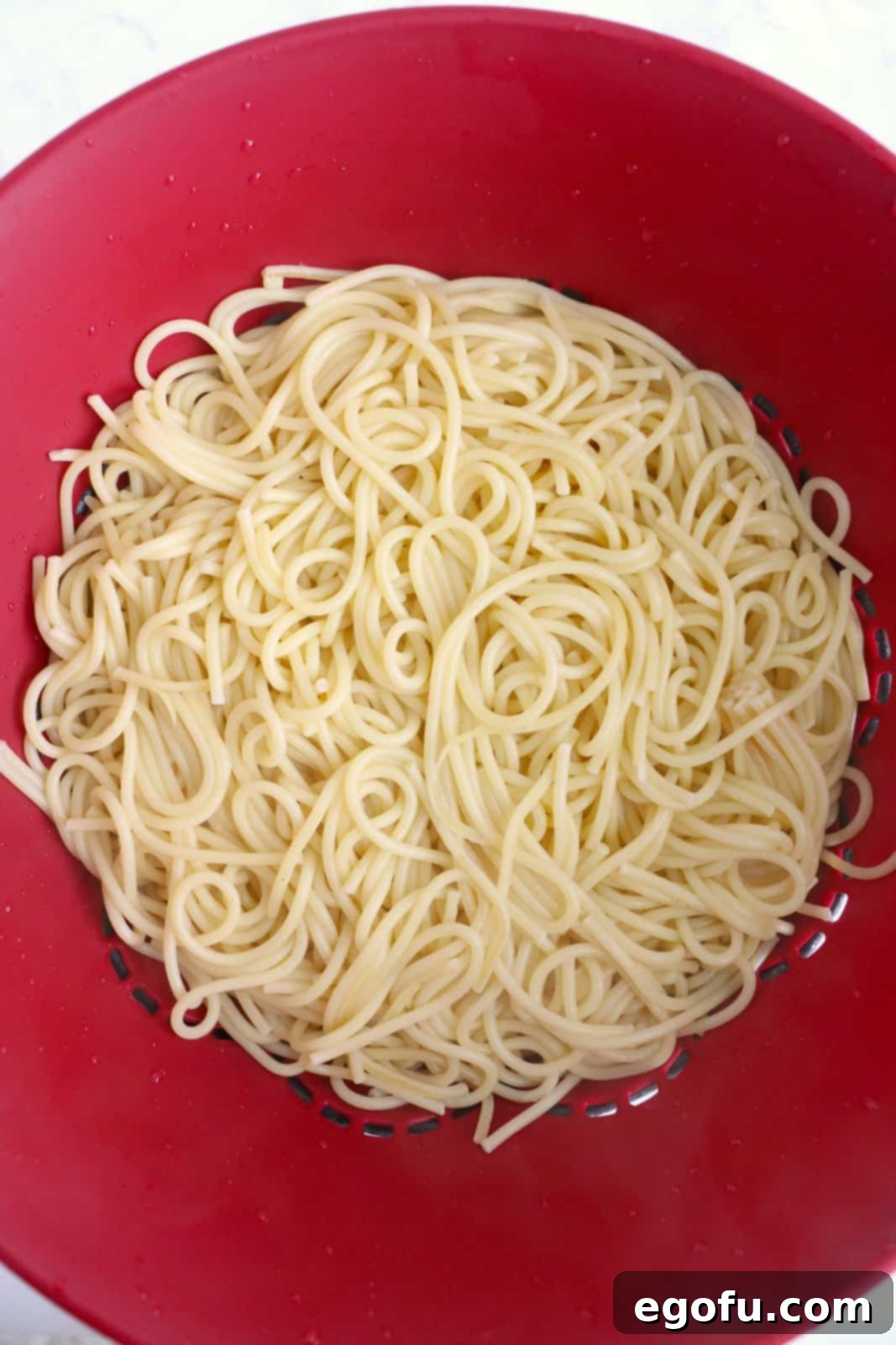 Our School's Spaghetti Day 10 Cooked spaghetti being drained.