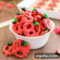 Close up square image of Back-to-School Chocolate Covered Pretzels in white bowl with a few pretzels leaning against bowl.