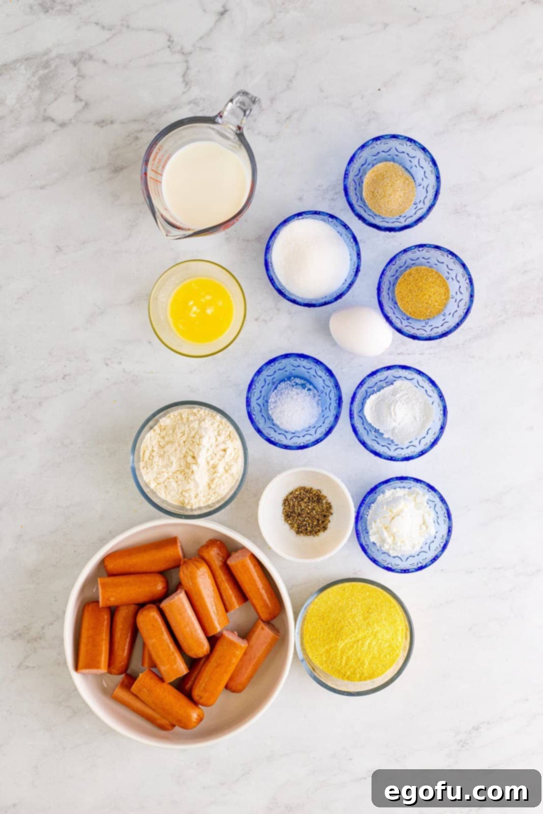 Ingredients needed: peanut oil, hot dogs, cornstarch, fine yellow cornmeal, all-purpose flour, granulated sugar, baking powder, garlic powder, onion powder, kosher salt, pepper, whole milk, unsalted butter and egg.