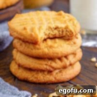Close up square image of Lunch Lady Peanut Butter Cookies with a bite taken out of the top one.