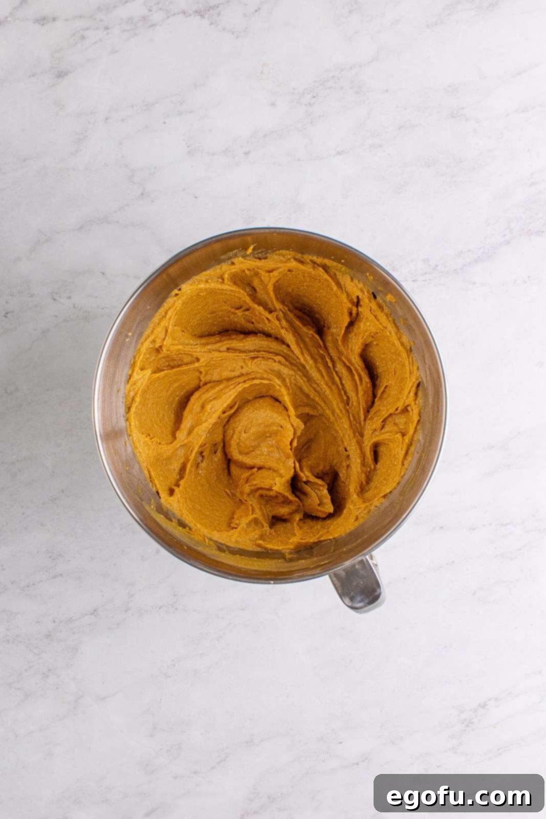 The brown sugar and granulated sugar fully mixed into the butter and peanut butter mixture.