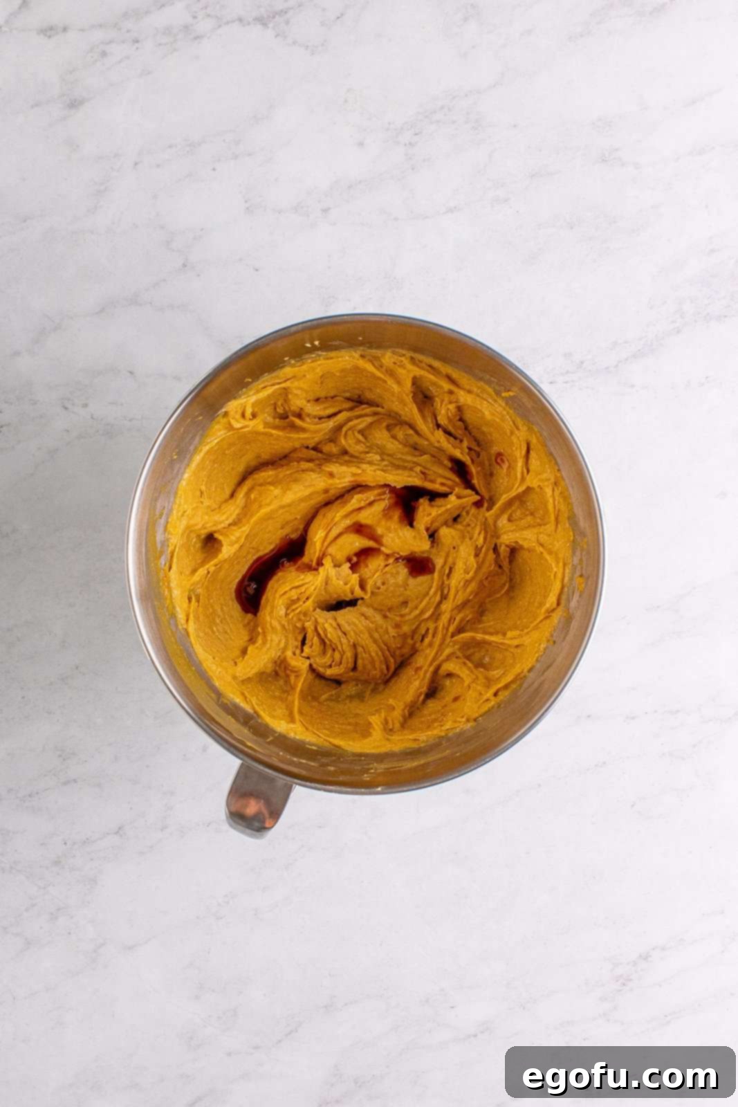 Vanilla extract added to the stand mixer with the wet ingredients.