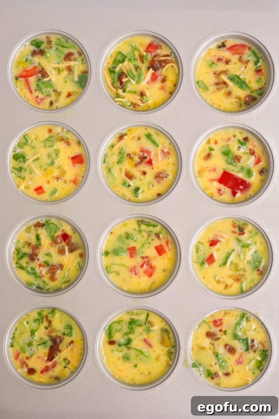 Egg mixture put into wells of muffin tin.
