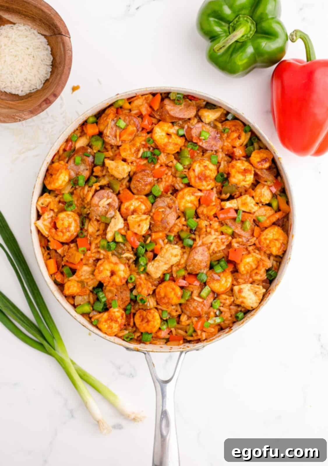 Finished Louisiana Jambalaya stirred together and garnished with fresh green onions, ready for serving.