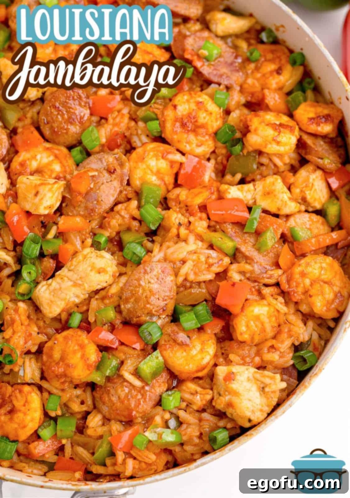 Overhead shot of Louisiana Jambalaya simmering in a large pan, ready to be served, highlighting the vibrant ingredients.