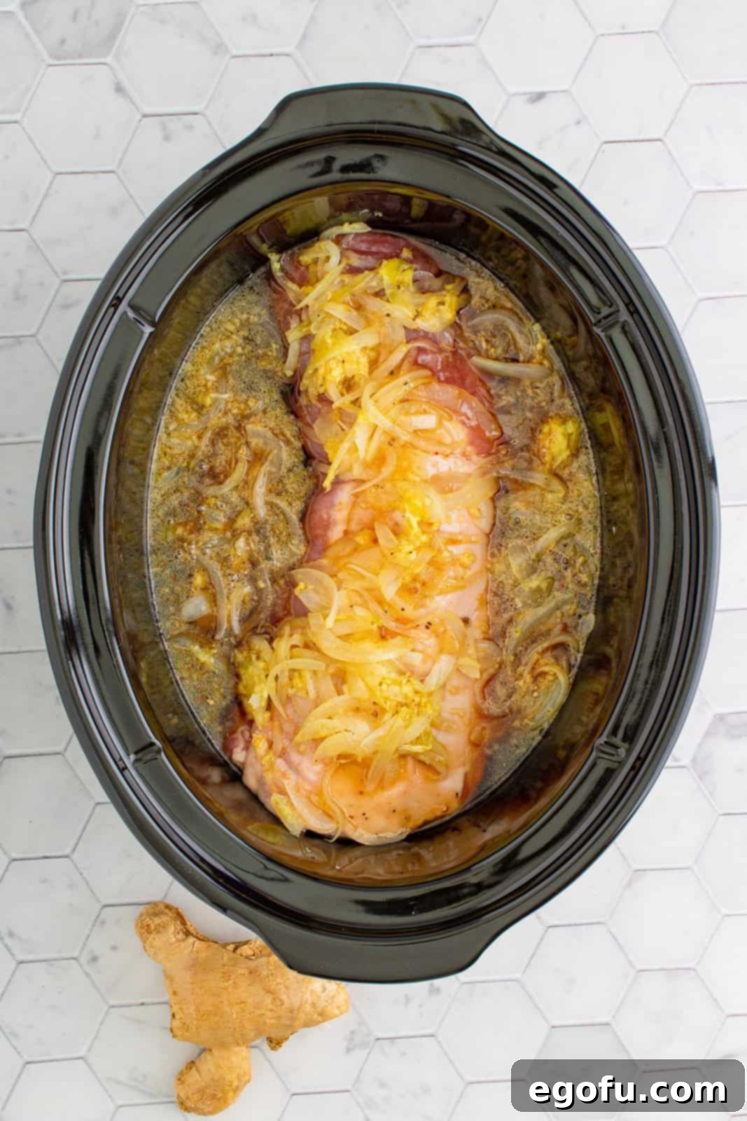 Effortless Crock Pot Pork Loin 6 Liquid mixture poured over the top of the pork loin in crock pot.