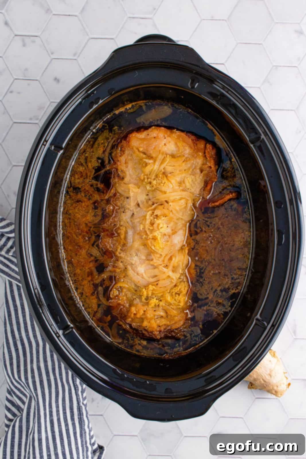 Effortless Crock Pot Pork Loin 7 Finished pork loin in crock pot with gravy.