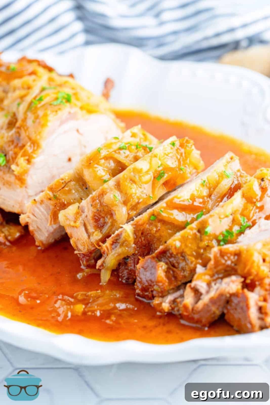 Effortless Crock Pot Pork Loin 9 Sliced up Crock Pot Pork Loin on platter covered in gravy.