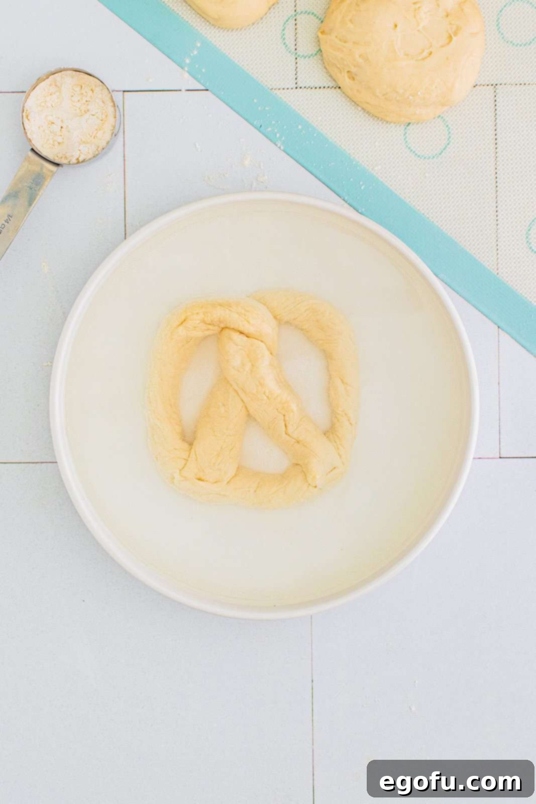 Pretzels carefully placed into the baking soda water bath.