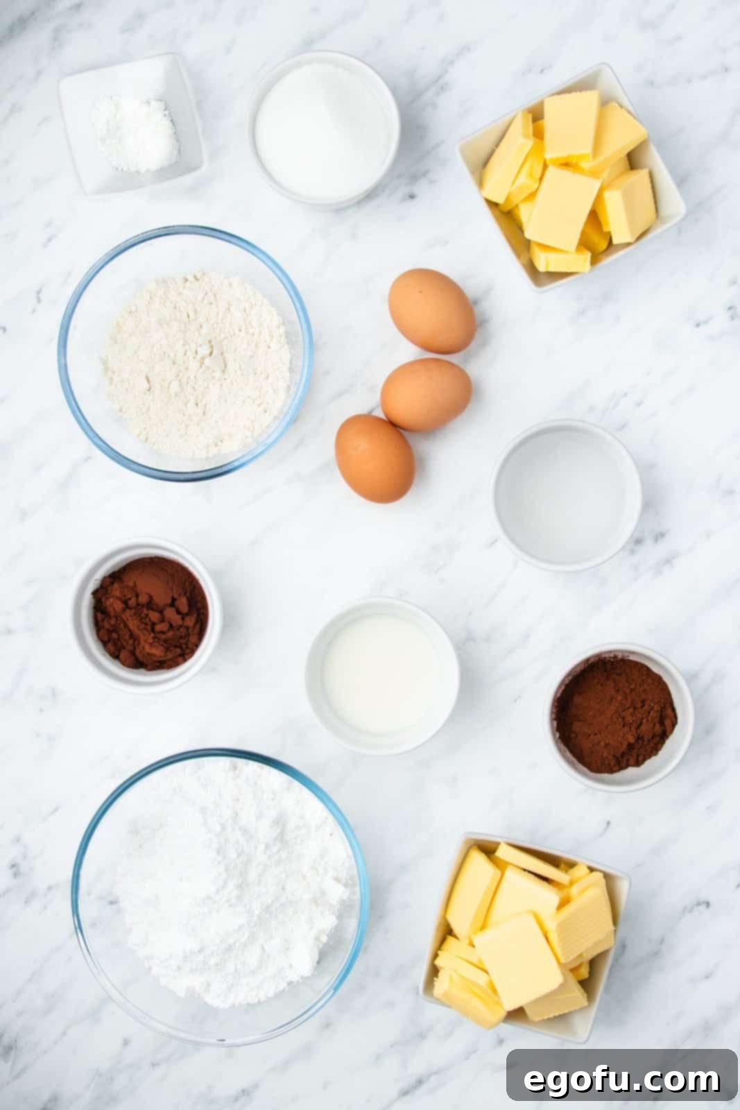 Ingredients needed: cocoa powder, boiling water, eggs, unsalted butter, granulated sugar, all-purpose flour, baking powder, powdered sugar, milk and chocolate sprinkles.