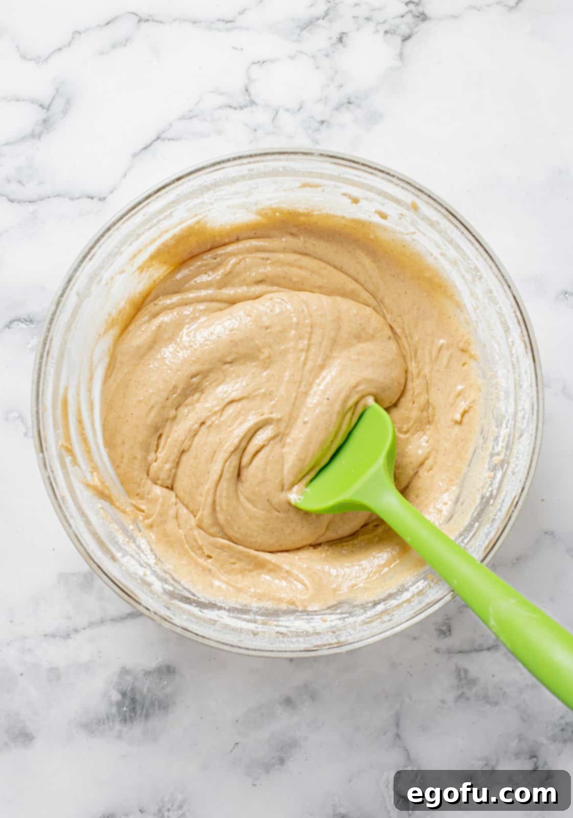 Dry ingredients added to wet ingredients and mixed together in bowl.