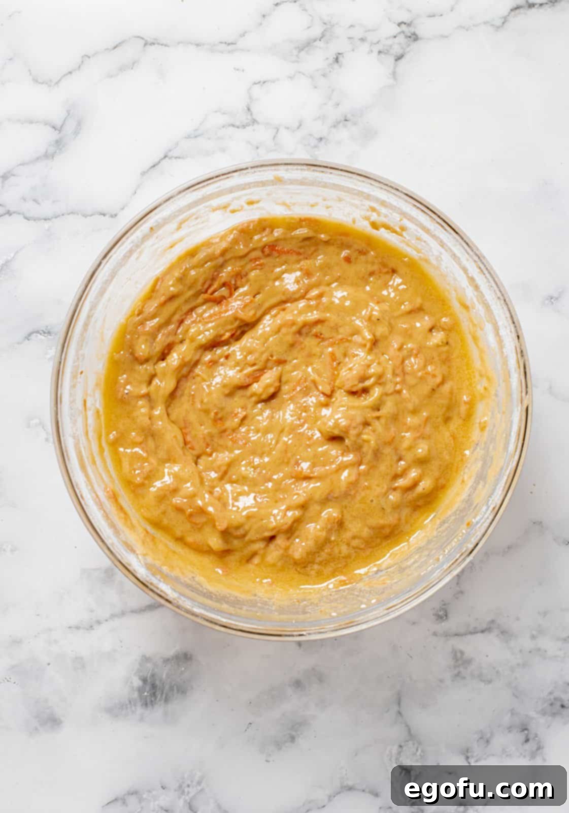 Grated carrots and walnuts folded into batter.