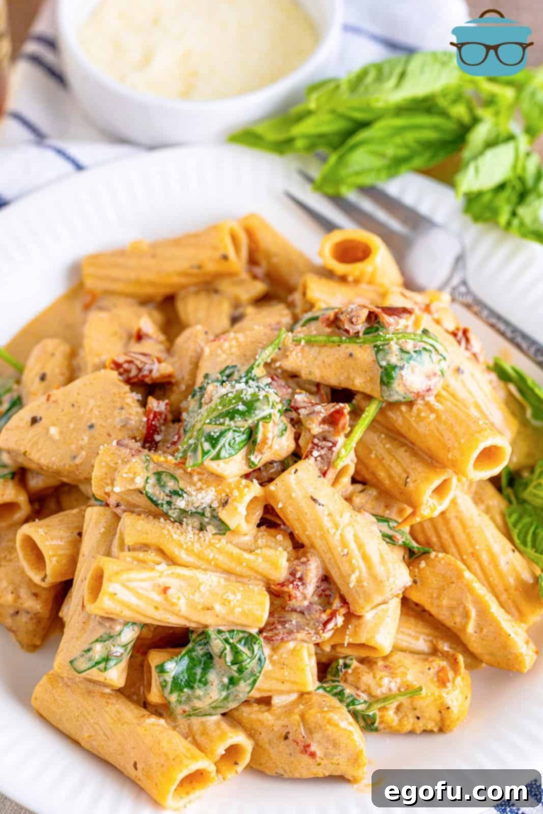 Tuscan Chicken Pasta overhead slightly on white plate, showcasing the rich sauce and perfectly cooked pasta.