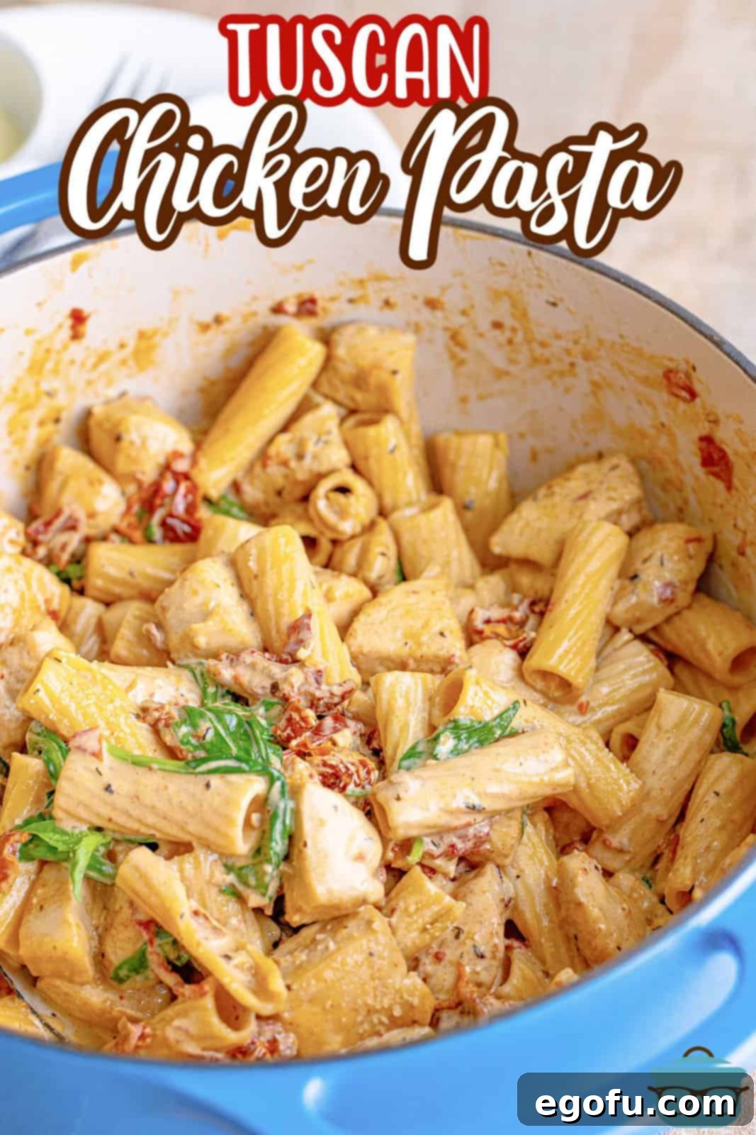 Pinterest image of finished Tuscan Chicken Pasta in dutch oven, ready to be served.