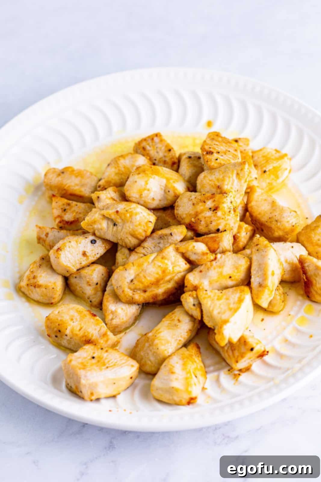 Cooked chicken removed to plate, showing a golden brown crust.