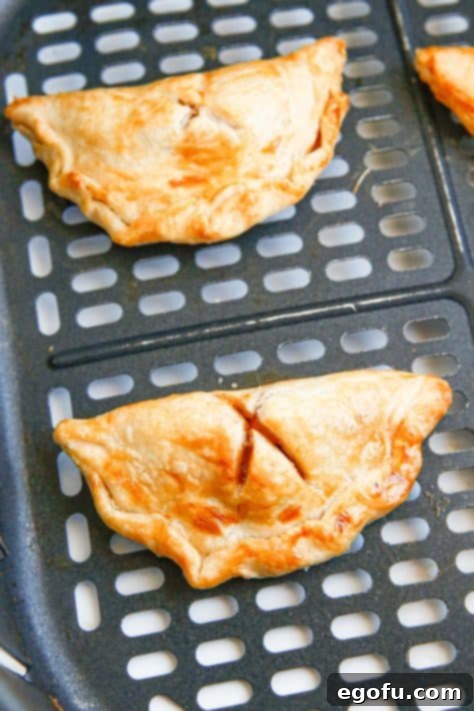 Finished hand pies in air fryer basket.