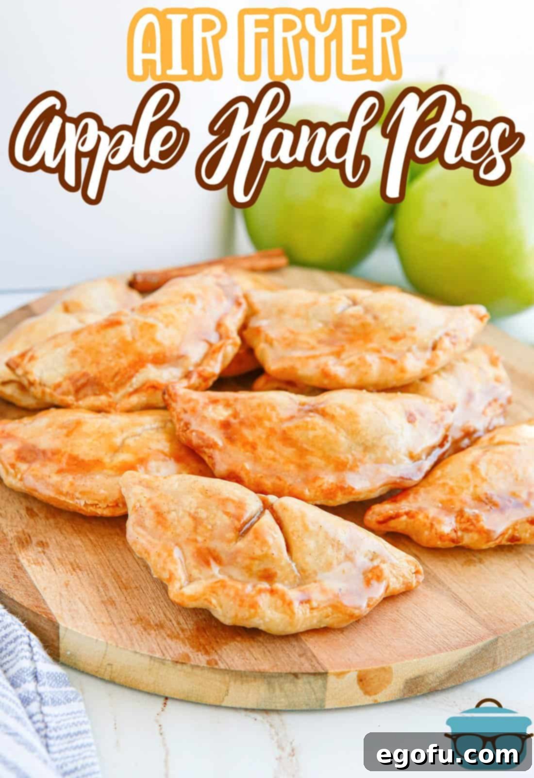 Pinterest image of Air Fryer Apple Hand Pies on wooden board glazed.