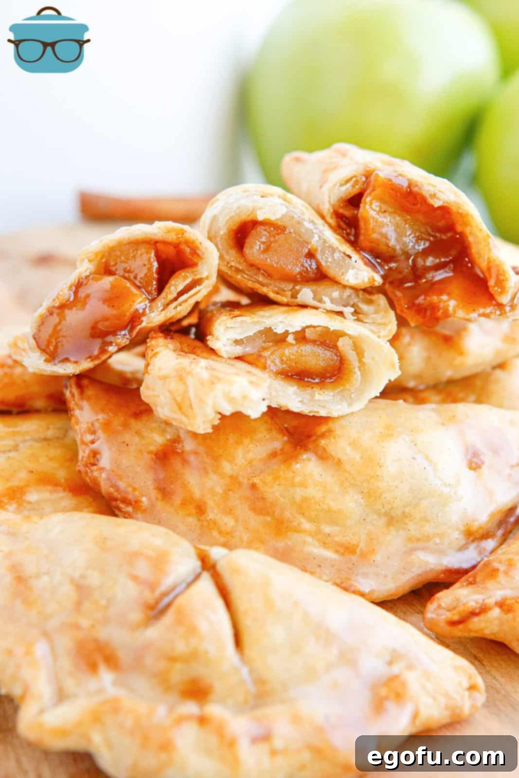 Close up of Air Fryer Apple Hand Pies stacked with split ones on top showing inside.