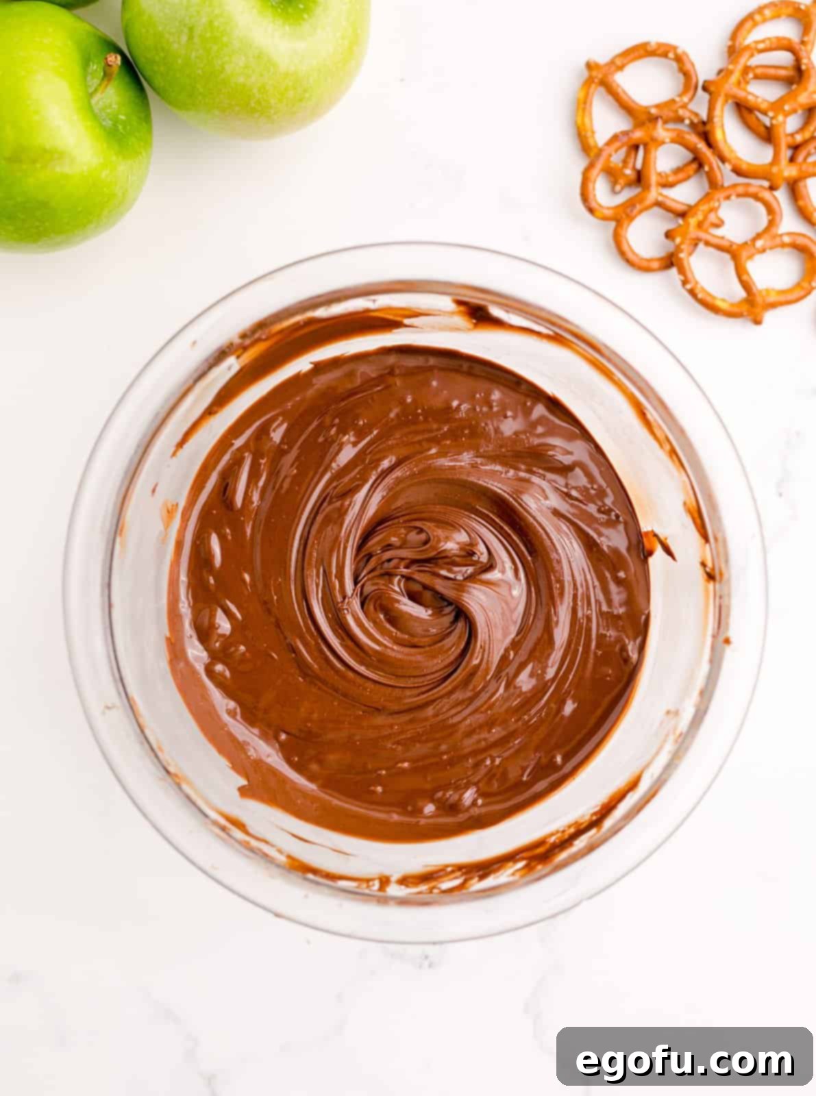 Melted chocolate chips in a microwave-safe bowl, ready for spreading.