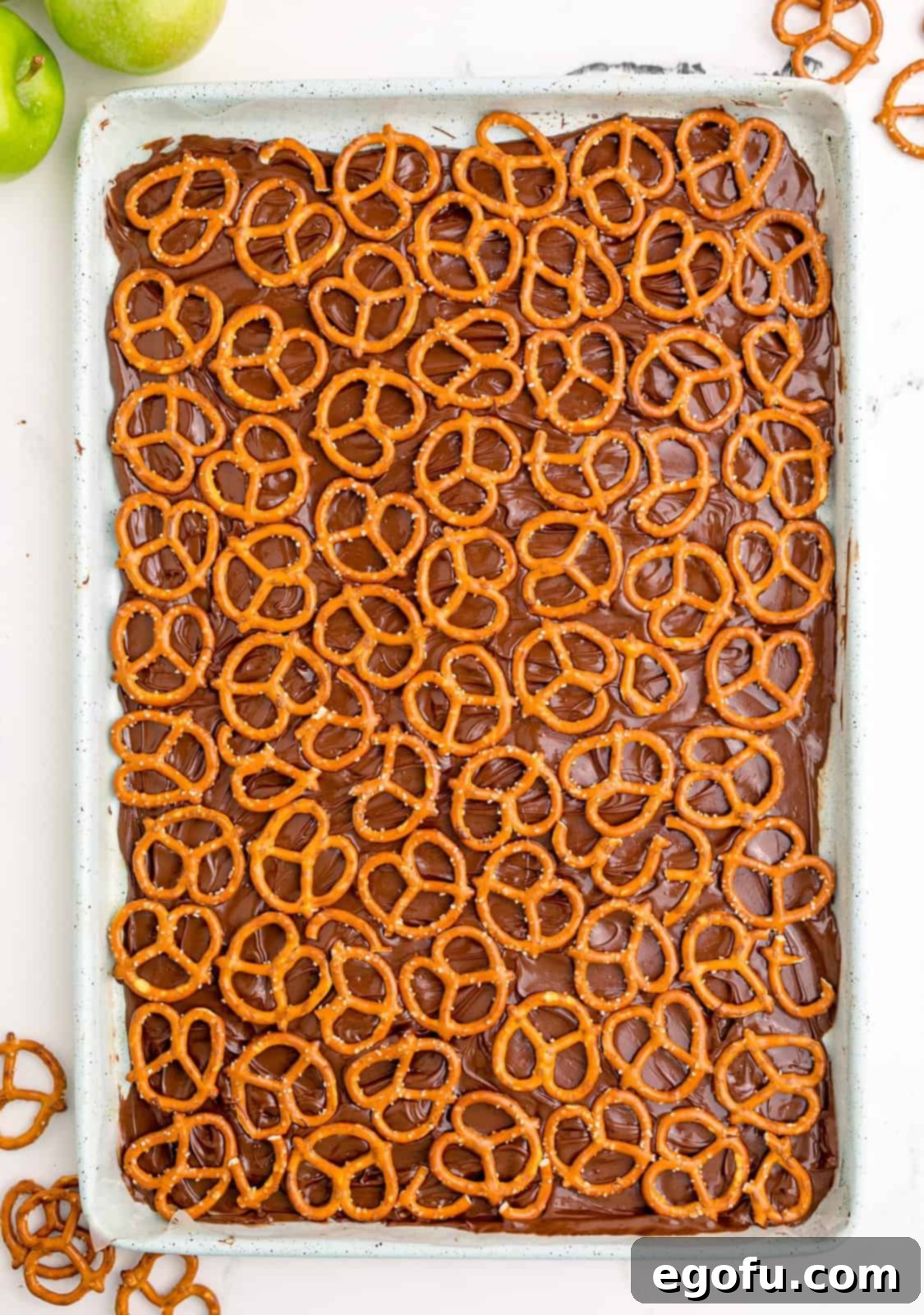 Pretzels carefully placed in a single layer over the melted chocolate base.
