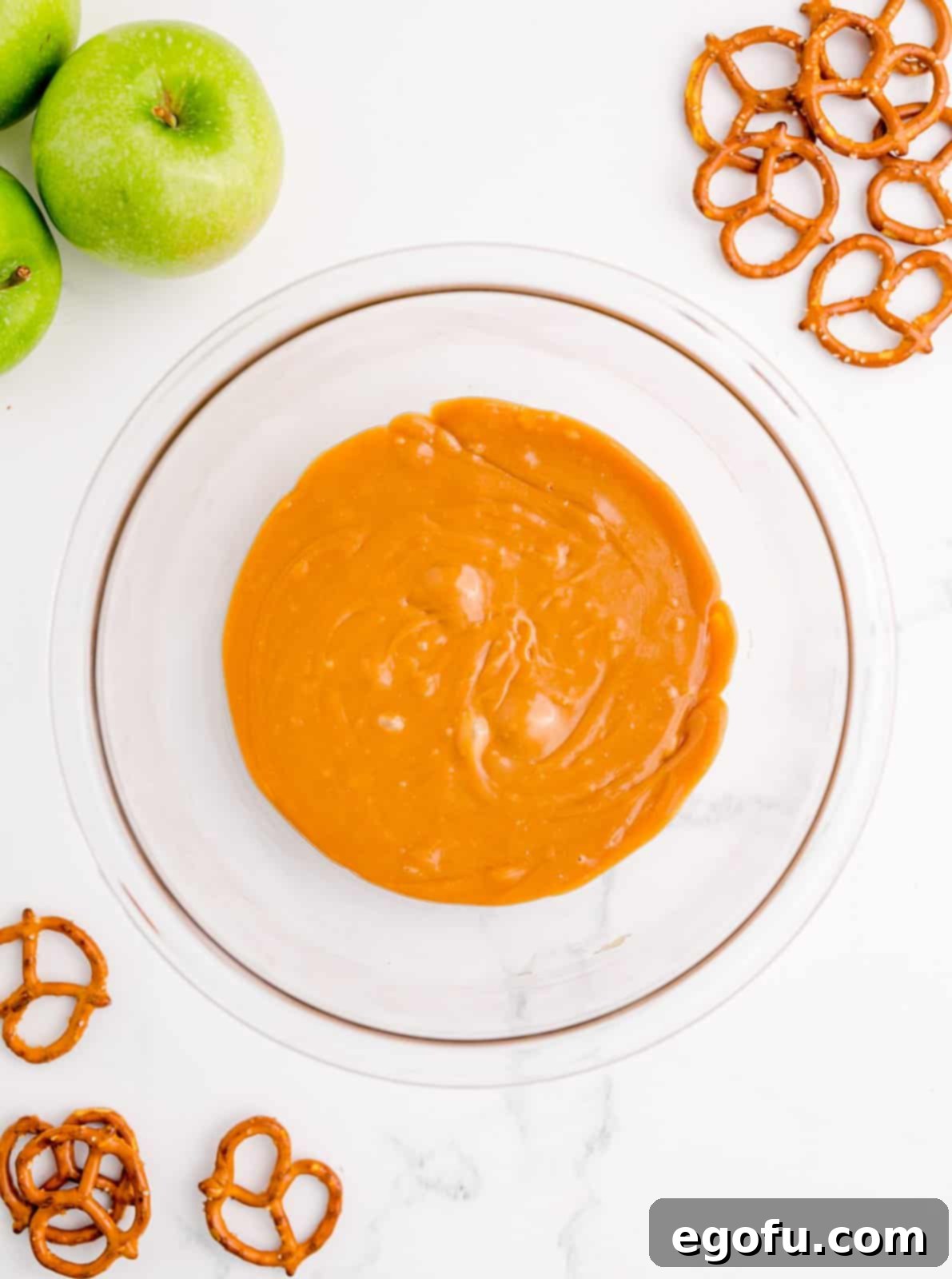 Smooth, melted caramel bubbling gently in a microwave-safe bowl.