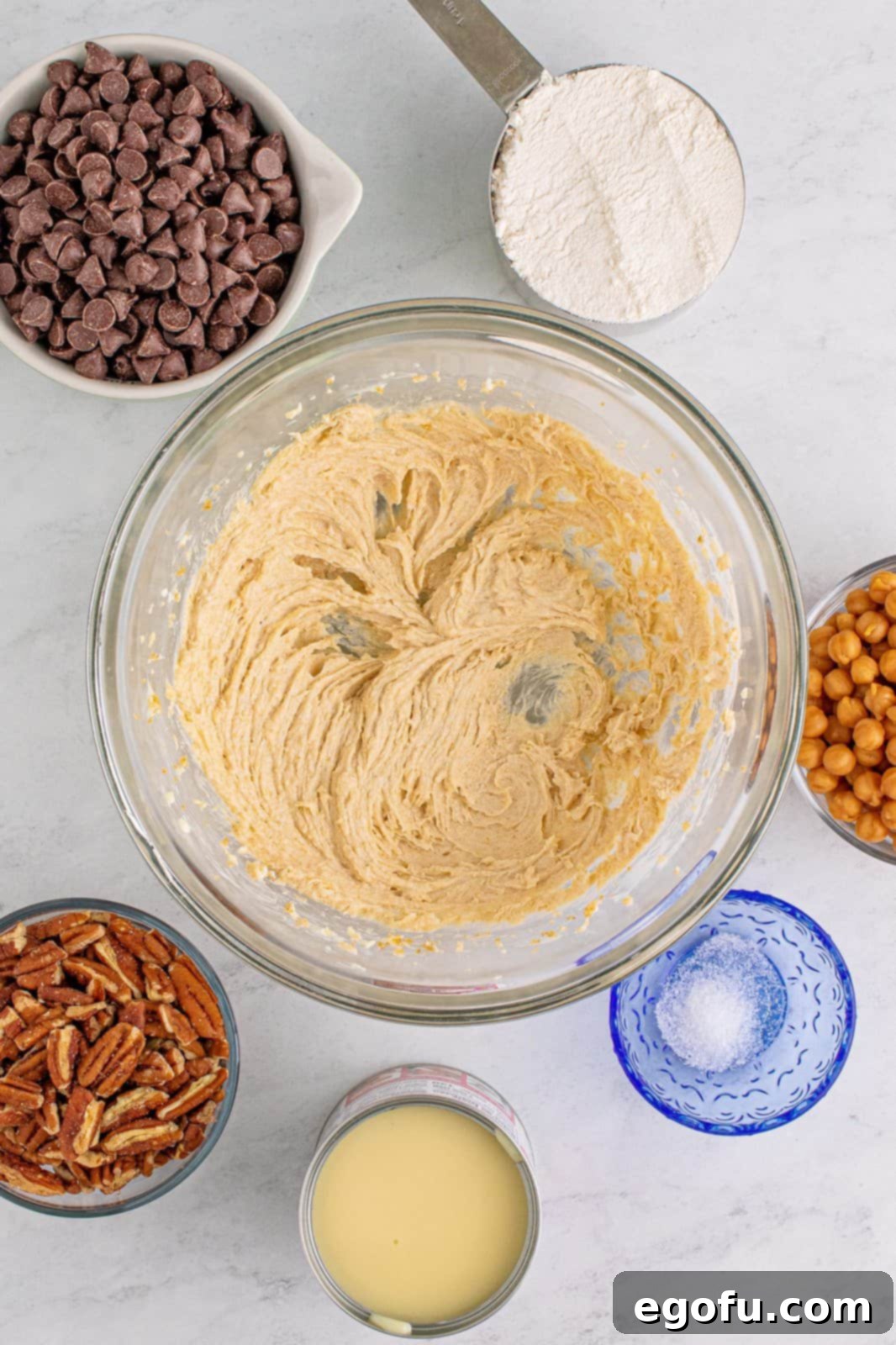 Butter and brown sugar being beaten together in a bowl until light and creamy.