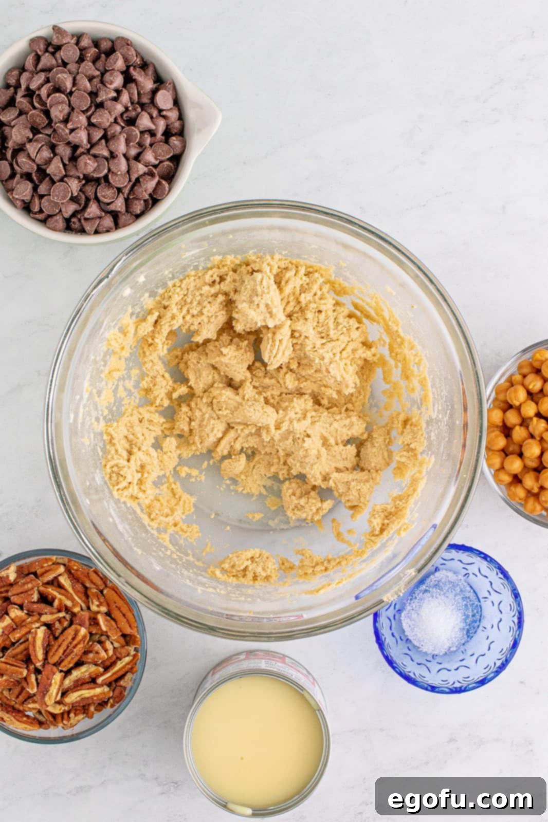 The mixed dough, now forming a cohesive ball in the bowl, ready for pressing into the pan.