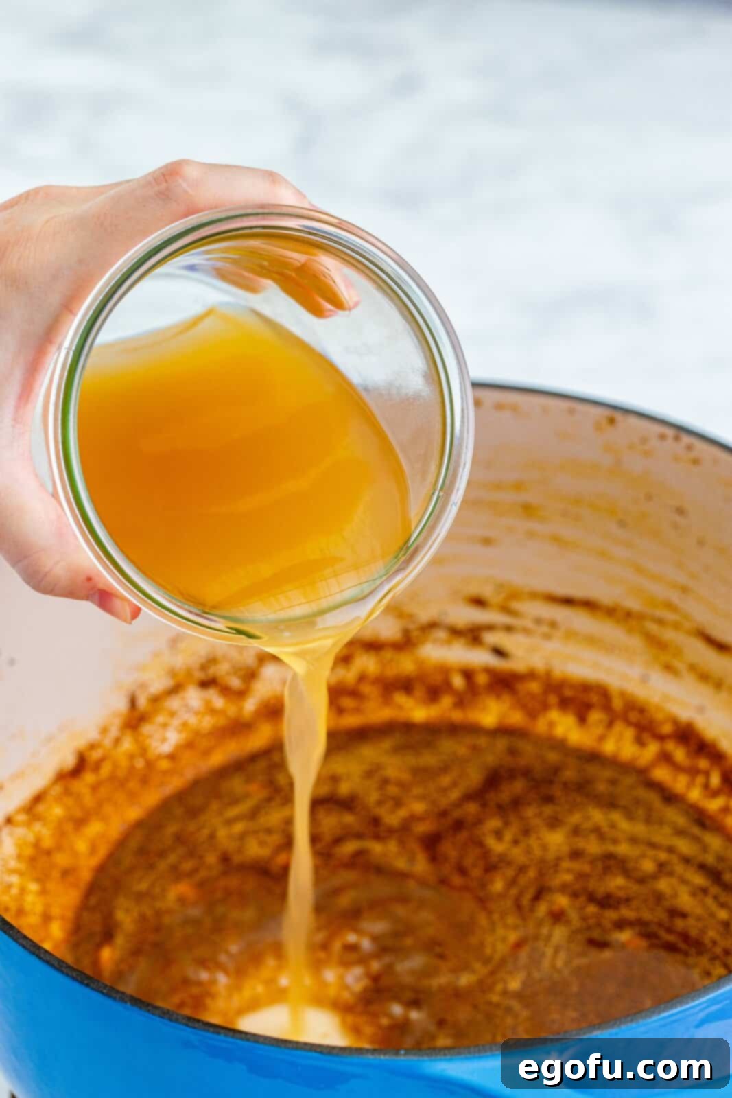 Southwest Chicken Enchilada Bowl 8 Stock being added to dutch oven.