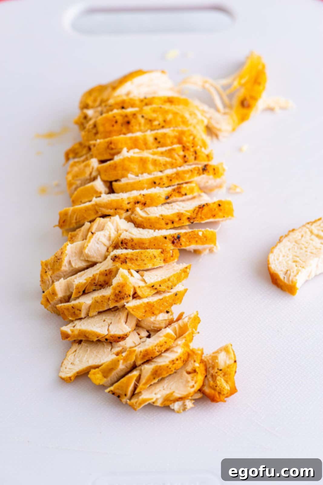 Southwest Chicken Enchilada Bowl 9 Chicken breast cut up on cutting board.