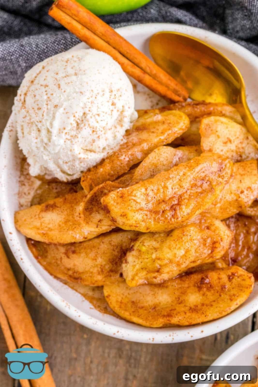 Overhead of Air Fryer Fried Apples in white bowl with ice cream, ready to be served.