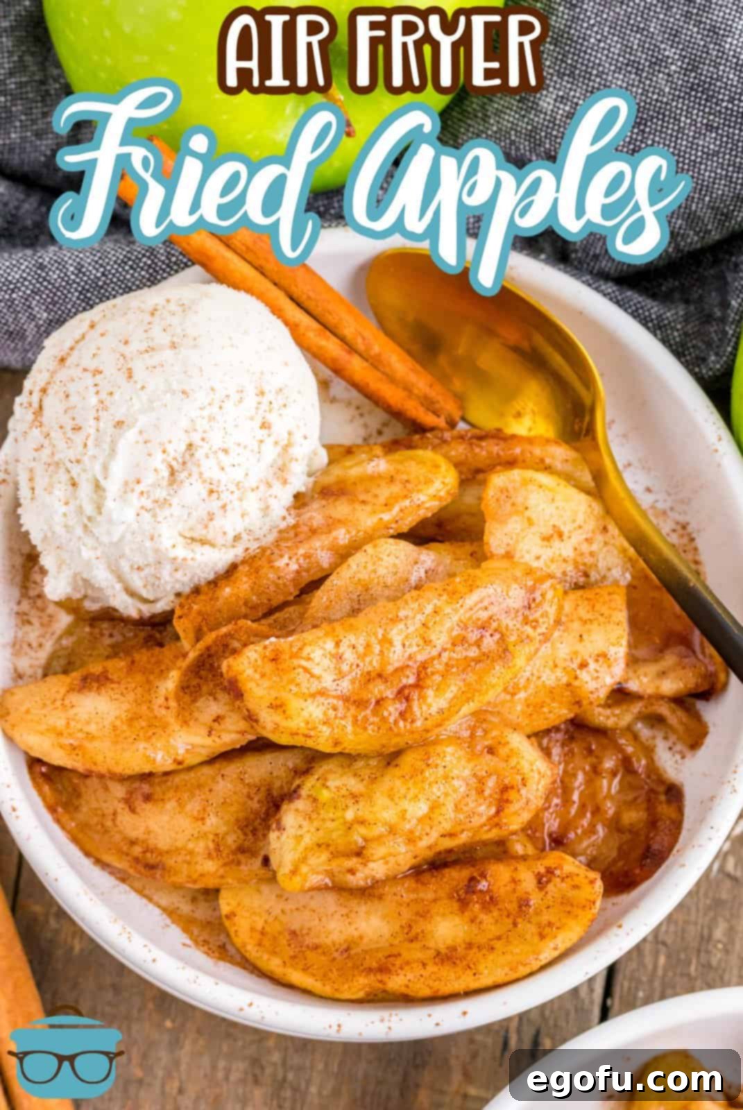 Overhead of Air Fryer Fried Apples in bowl with ice cream, cinnamon stick and spoon, Pinterest image, showcasing their golden-brown perfection.