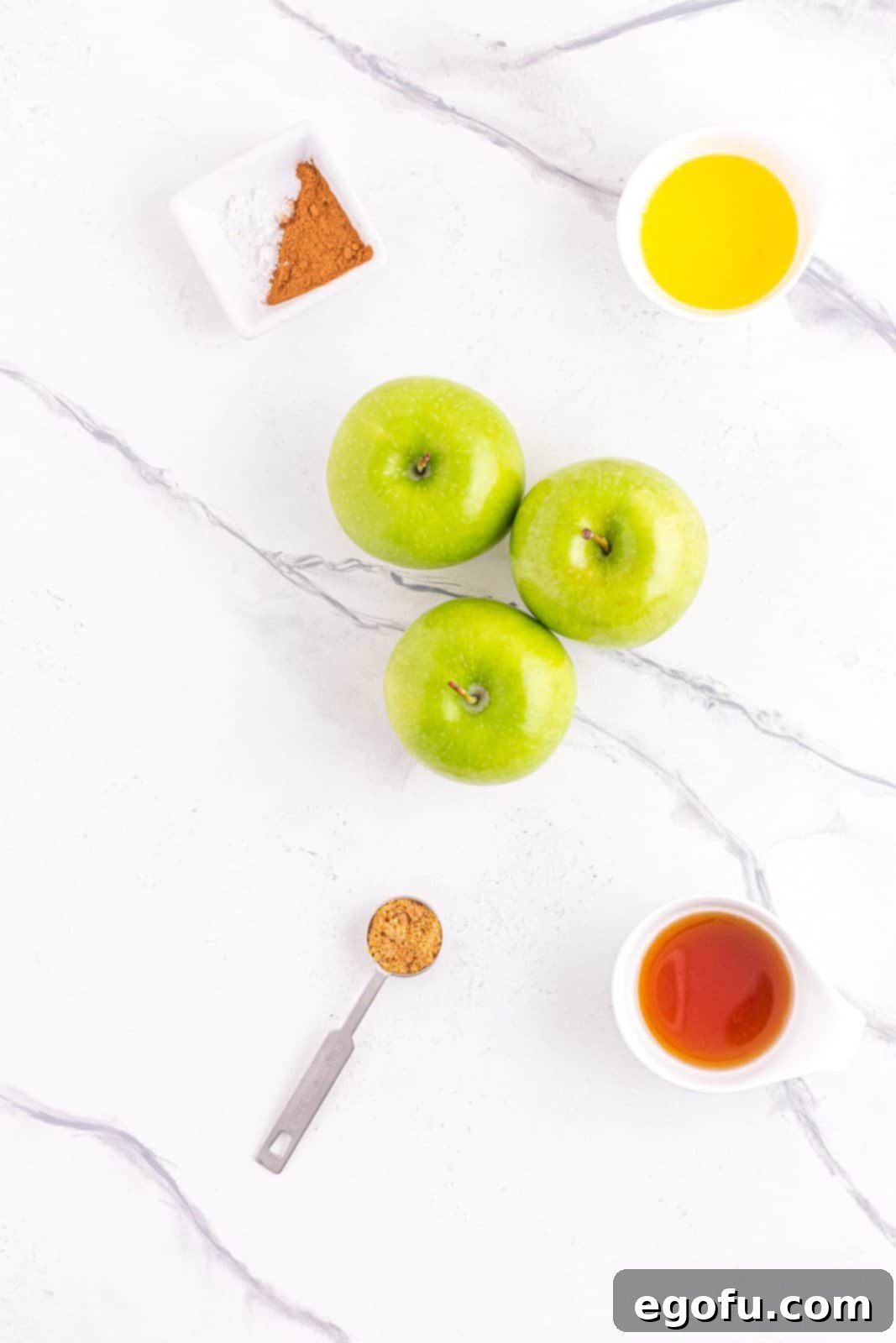 Ingredients needed: apples, brown sugar, cinnamon, sea salt, pure maple syrup and unsalted butter, neatly arranged for preparation.