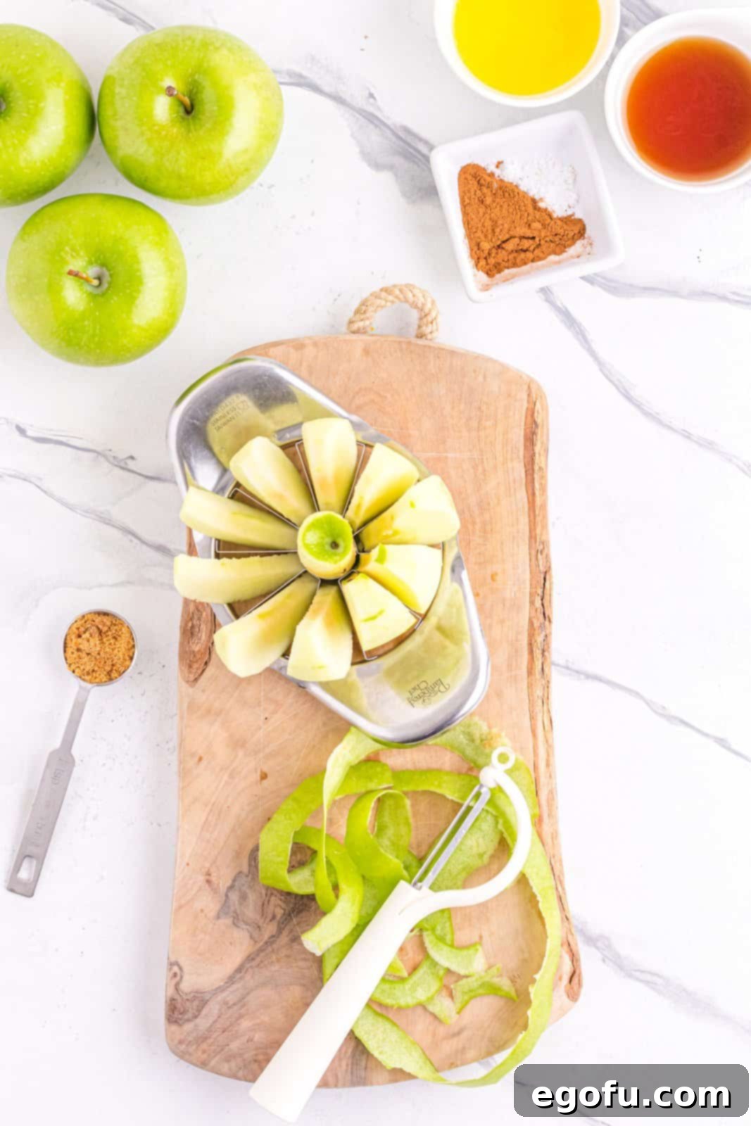 Apples being peeled, sliced and cored, illustrating the initial preparation stage.