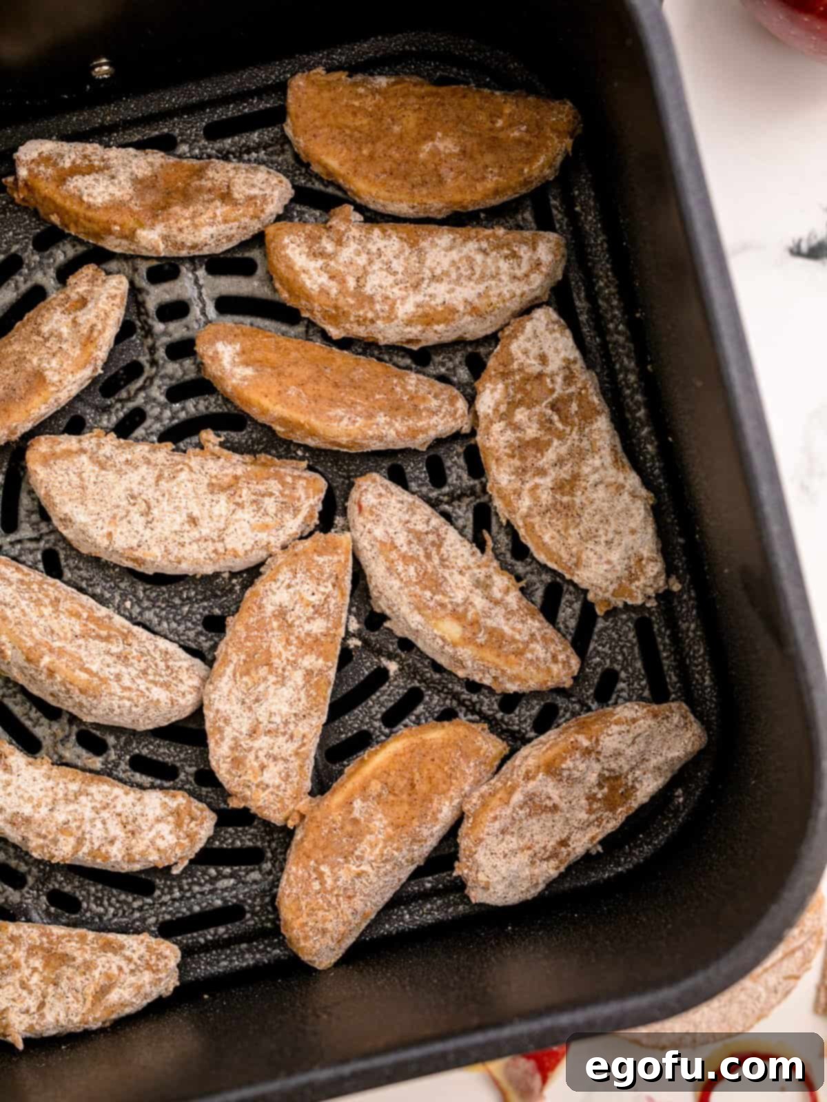 Apples placed in basket of air fryer.