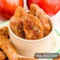 Close up square image of Air Fryer Apple Fries in white bowl on platter.