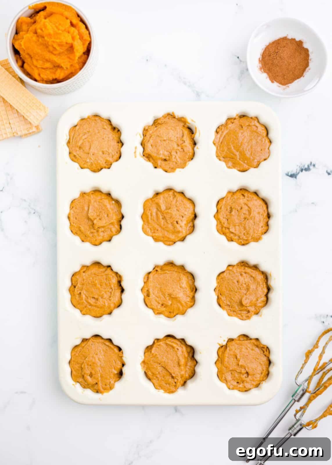 Cake batter in mini bundt pan.
