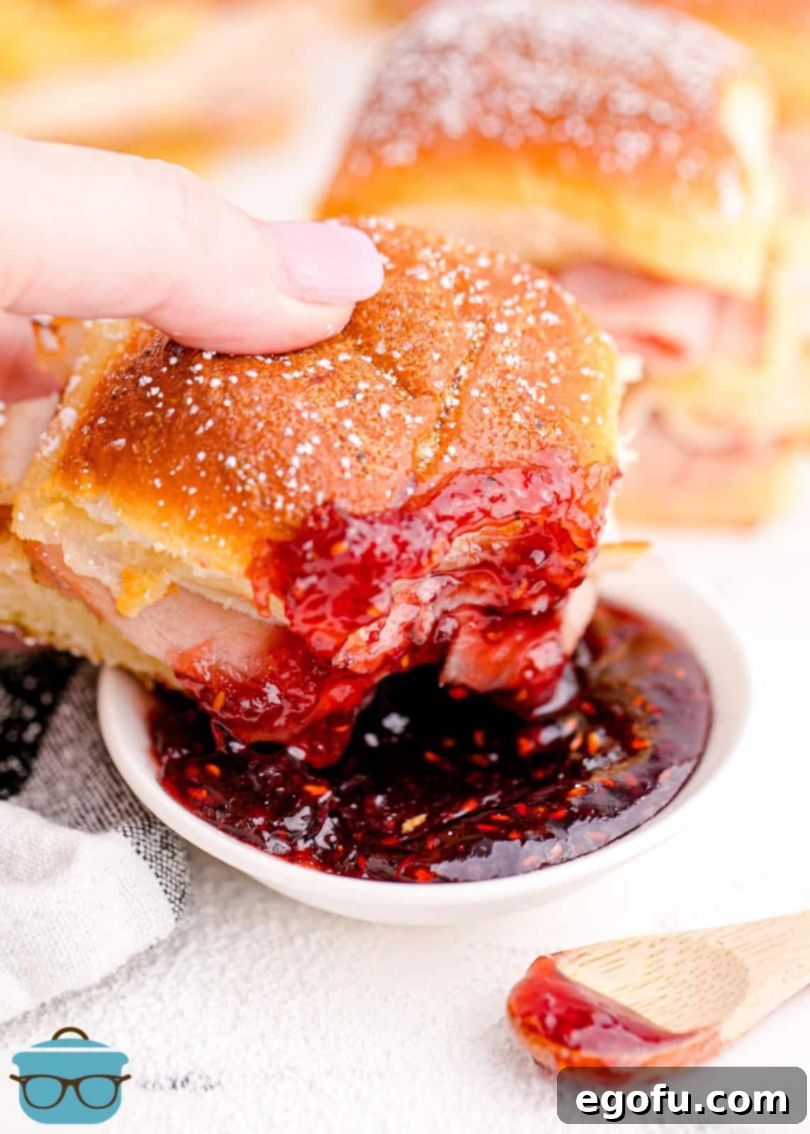 Hand dipping one of the Monte Cristo Sliders in the preserves.