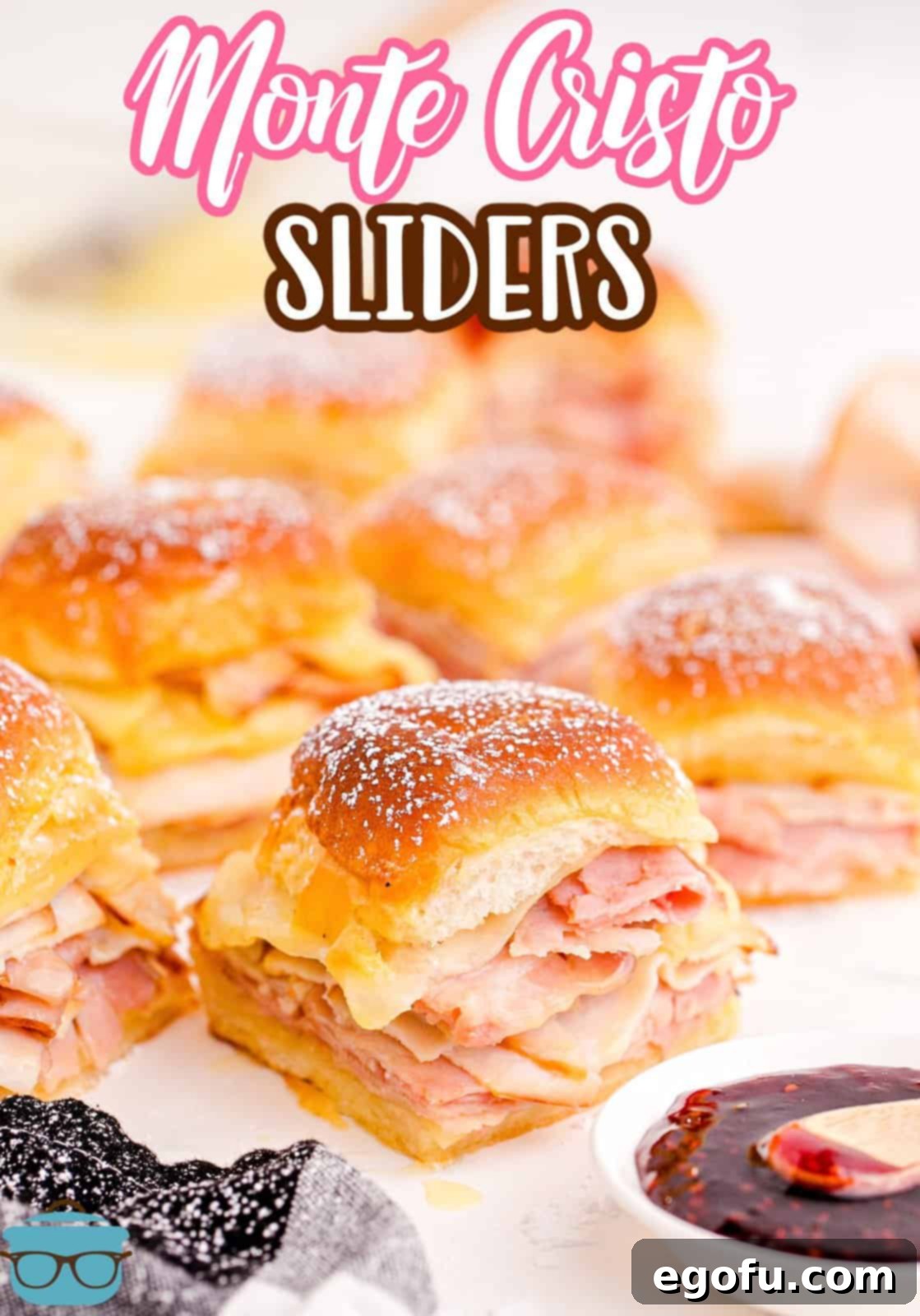 Pinterest image of cut up and spread out Monte Cristo Sliders with preserves in front.