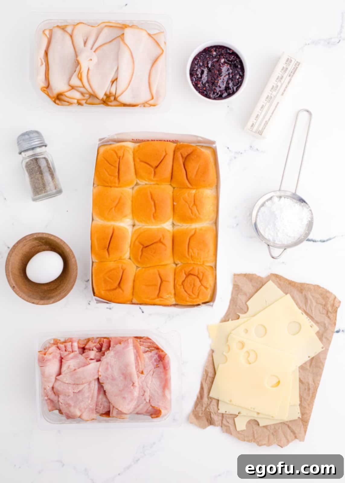 Ingredients needed: hawaiian rolls, ham, turkey, swiss cheese, salted butter, egg, pepper, powdered sugar and raspberry or strawberry preserves, optional.